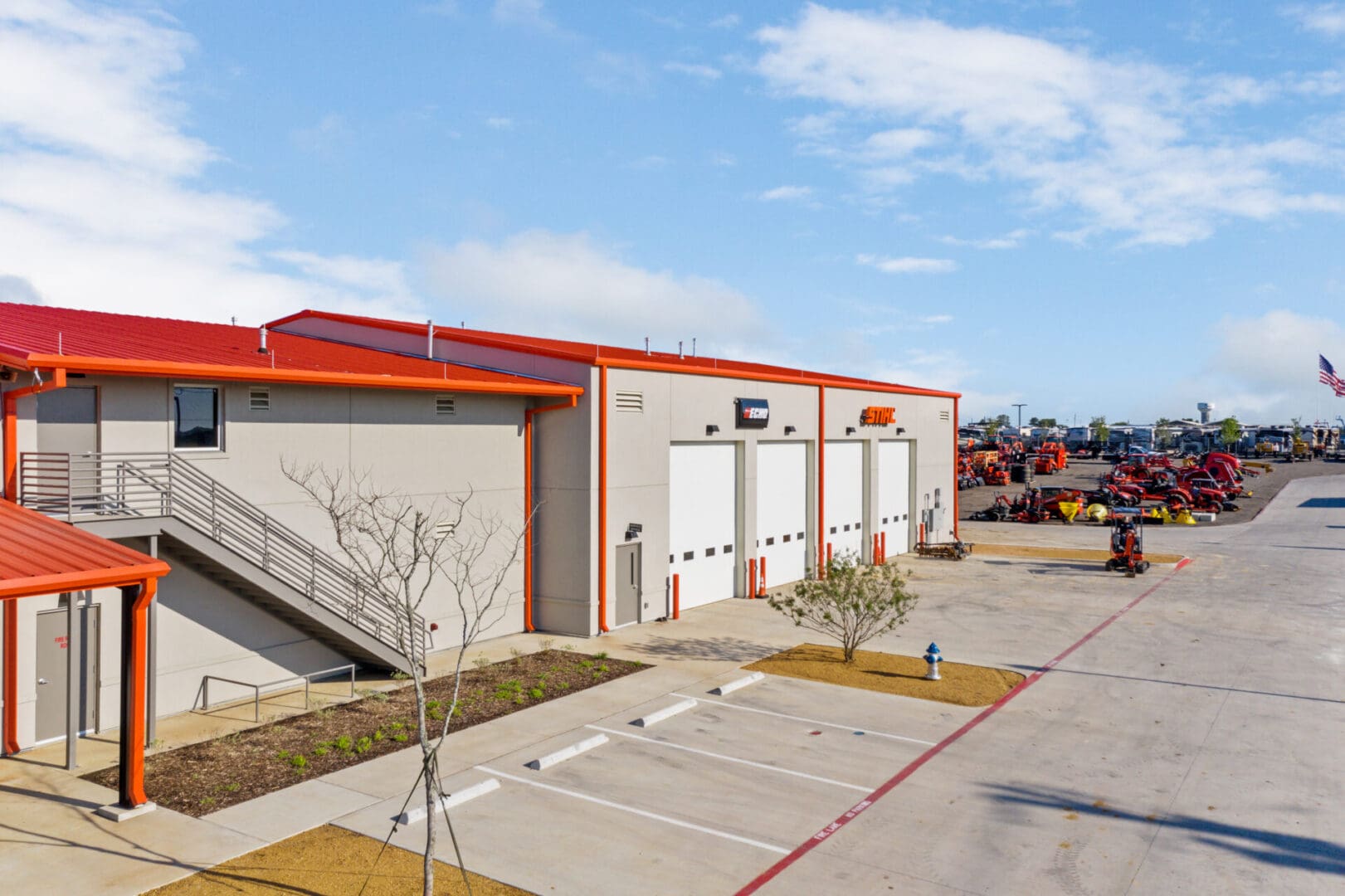 Side profile of a gray warehouse with an orange roof