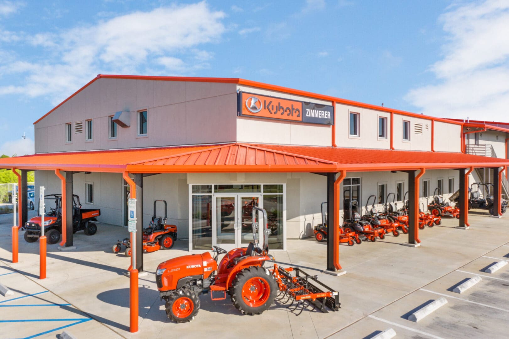 Side profile façade of a gray warehouse with an orange roof