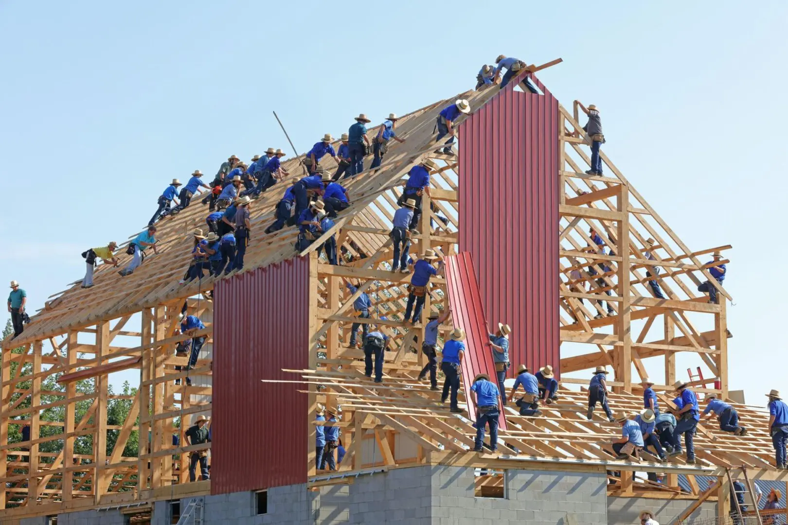 several workers working on a wood and brick building