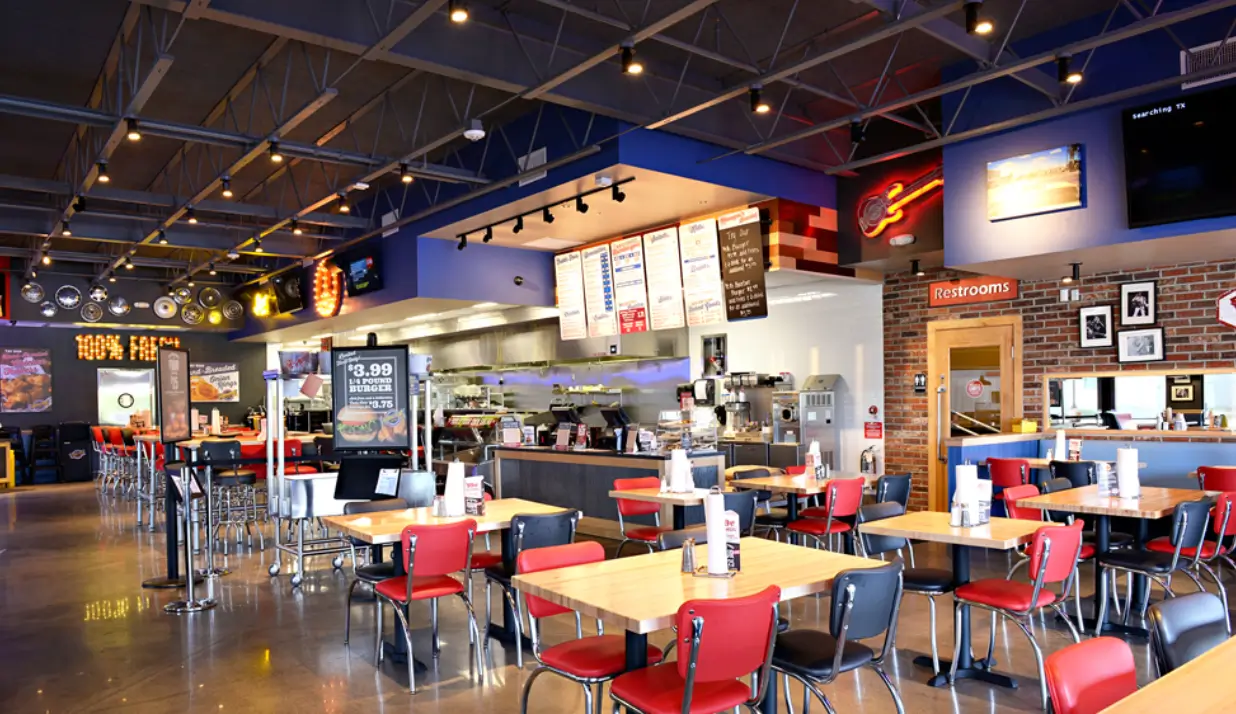 An empty food court with stores and table for eating